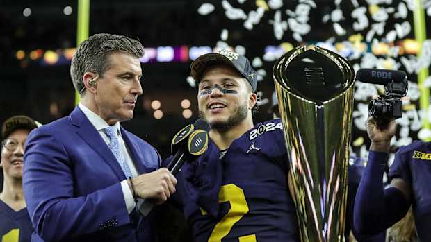 Michigan running back Blake Corum (2), along with Rece Davis, celebrates the Wolverines' 34-13 win over Washington at the national championship game at NRG Stadium in Houston on Monday, Jan. 8, 2024.